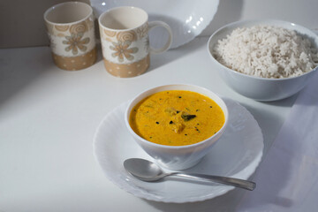Delicious south Indian style mango curry with white rice, white background