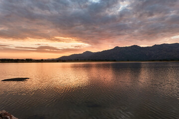 Sunset in the Santillana Reservoir with La Pedriza and the Sierra de Guadarrama in the background. Madrid's community. Spain