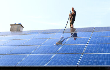 Cleaning solar panels with brush and water