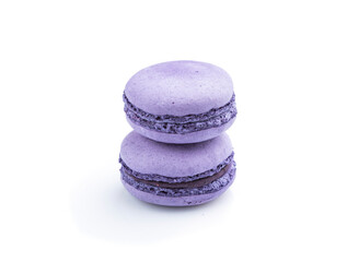 Purple macarons or macaroons cakes isolated on white background. Side view.