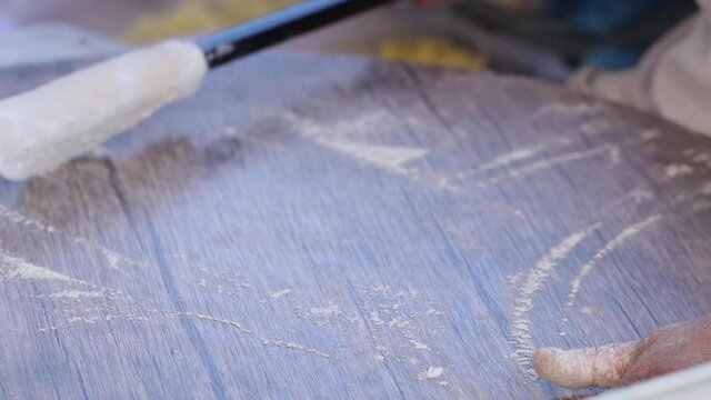 Making gozleme dough by close up female hands in kitchen. Shaping dough is precursor to making a wide variety of food stuffs, particularly breads.