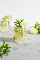 cold refreshing lemonade with mint on a light background