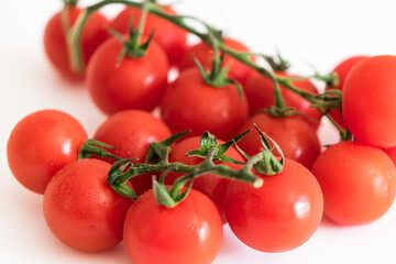 fresh red tomatoes on a green branch