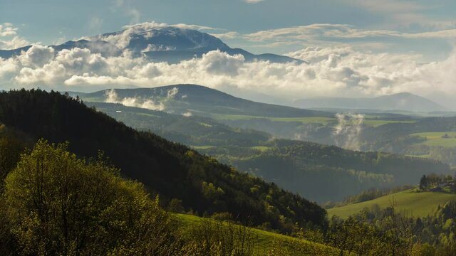 Moving Clouds over Hill after rain, green trees and great fields - Springtime
