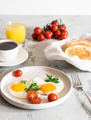fried eggs with tomatoes and herbs, toast, coffee and juice