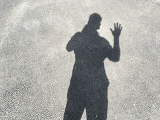 Silhouette of a man on the asphalt