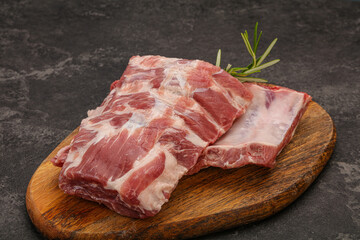 Raw pork ribs served rosemary