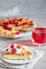 Delicious curd muffin with raspberries on a light background.