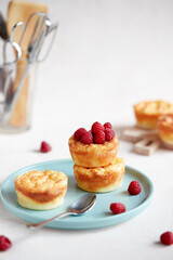Delicious curd muffin with raspberries on a light background.