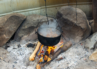 food prepared in a cauldron in a rustic style