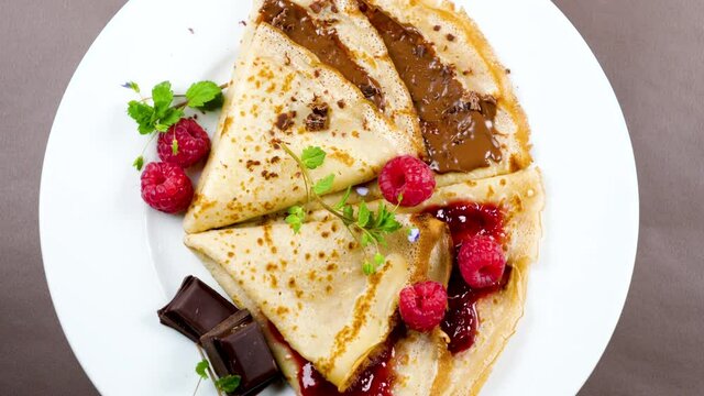 delicious crepe with chocolate and raspberry jam