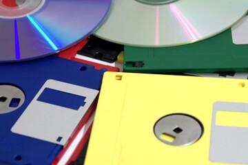 Old retro Computering media storage. Compact disc with floppy diskettes