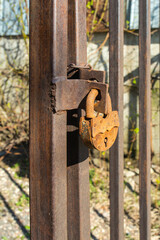 old rusty lock on a metal gate