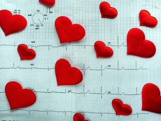 Medical background with hearts of different sizes located diagonally. The hearts are on the...