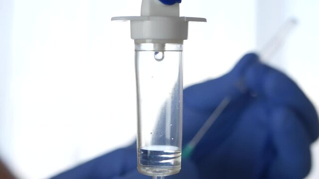 Medical Perfusion and the Hand of a Paramedic in Blur Using an Injection in a Hospital