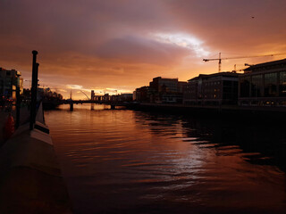 Fototapeta premium Sunrise over the River Liffey in Dublin. View from the river bank, towards the Dublin Port.