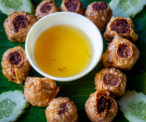 Deep Fried Crab Meat Rolls on wood table .close up food. for advertisement.