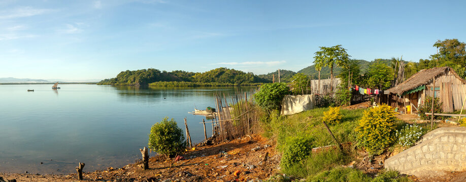 Traditional House Overlooking The Indian Ocean Near Port Ankify, Ambanja District, Northern Madagascar; In The Distance Two Boats Sail Out