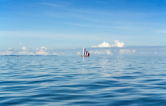 NOSY BE, MADAGASCAR: Traditional sailing boat on the Indian Ocean, blue sky and coean.