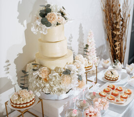 Candy bar at the banquet. Wedding table with sweets, cake, pastries, muffins, sugar treats. Event in the restaurant
