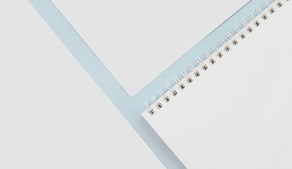 Office concept. Workspace notebook and pencil. Copy space white and blue background.