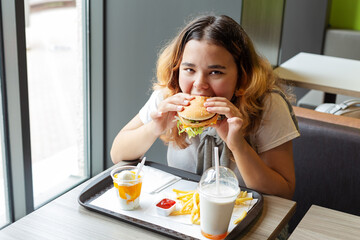 Junk food. Portrait  young girl. Close-up.