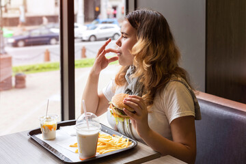 Junk food. Portrait  young girl. Close-up.