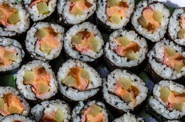Top view of stack of Japanese sushi maki roll plate. Served in Japanese bar restaurant with chopstick