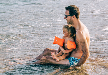 Father and daughter having fun on beach