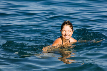 Happy woman swimming in sea