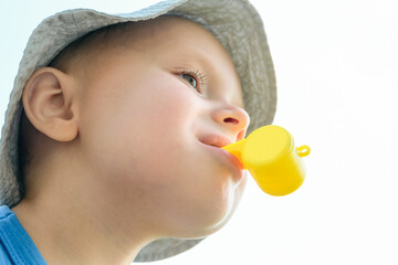 Little boy with a yellow whistle in his mouth