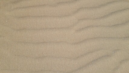 Fototapeta na wymiar Wavy sand texture background. Flat lay. Top view