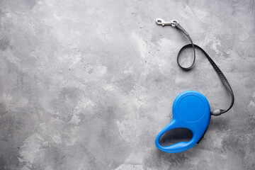 Leash tape measure for dogs on a gray background, space for text. Flat lay.