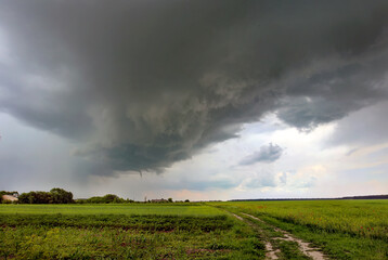 Fototapeta na wymiar Tornado atmospheric whirlwind in a cumulonimbus thundercloud