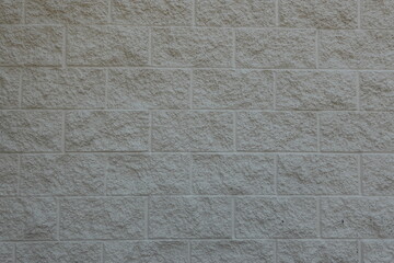 The surface of grey the brick and cement wall. 