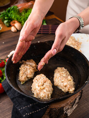 women's hands sculpt cutlets for frying in a pan
