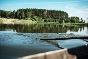 athletes on vacation are engaged in rowing, swimmers on wooden oars hit the water, splashing a lot of drops around