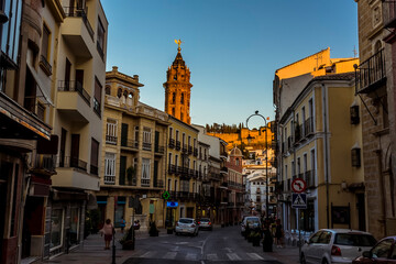 A view down the main street of Antequera, Spain towards the Moorish Alcazaba palace fortress on a summers evening