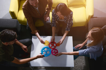 Business team connect pieces of gears. Teamwork, partnership and integration concept