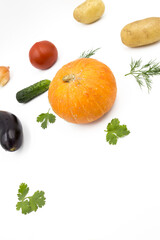 Fresh vegetables on a white background, flat lay: Potatoes, pumpkin, dill, tomato, cucumber, coriander. Healthy food, vegan food.