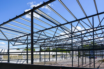 Fototapeta premium construction of a new modern industrial building, metal truss frame
