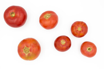 Fresh tomatoes on a white background, flat lay. Healthy food, vegan food.