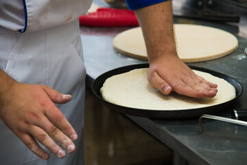 Professional chef prepares a closed meat pie