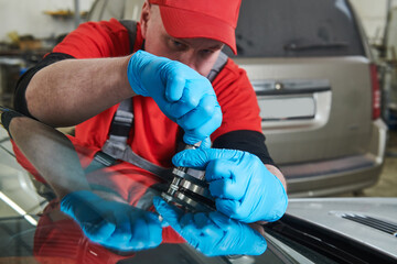automobile windshield glass repair service. Car glass or chip crack repairing
