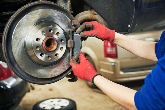 Automobile brake pads replacement in car repair shop or garage