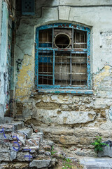 Fototapeta na wymiar Old window with iron bars
