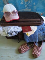 Open brown suitcase with women