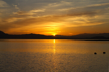 Sun cresting the horizon over a lake