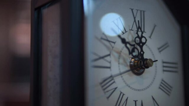 Vintage white clock face with Roman numerals close up stock footage.