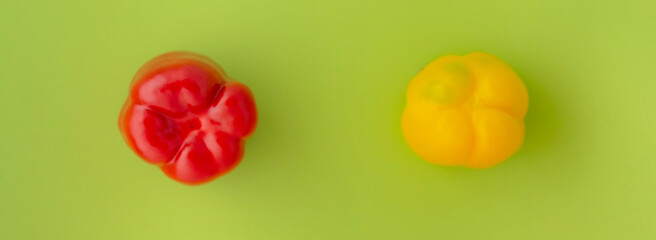 Fototapeta premium red and yellow bell peppers on a yellow background. Vegetables.